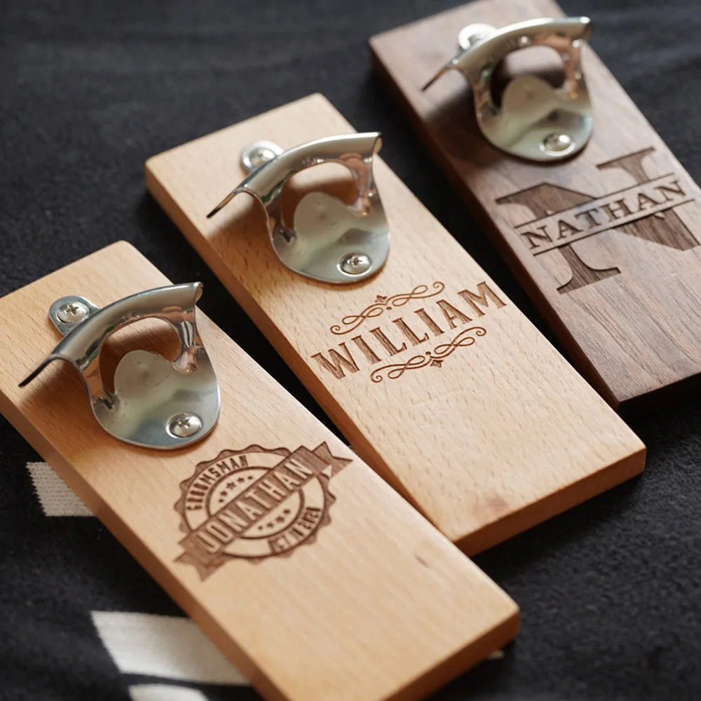 Personalized wooden bottle openers with engraved names.