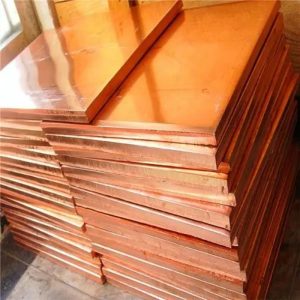 Stack of copper sheets in warehouse.