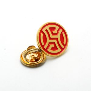 Gold and red circular cufflinks on white background.