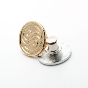 Gold magnetic snap button on white background.