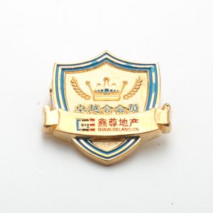 Gold shield badge with company logo and crown.