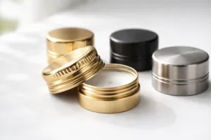 Decorative custom bottle caps showing gold, black, and nickel finishes with inner seal liners