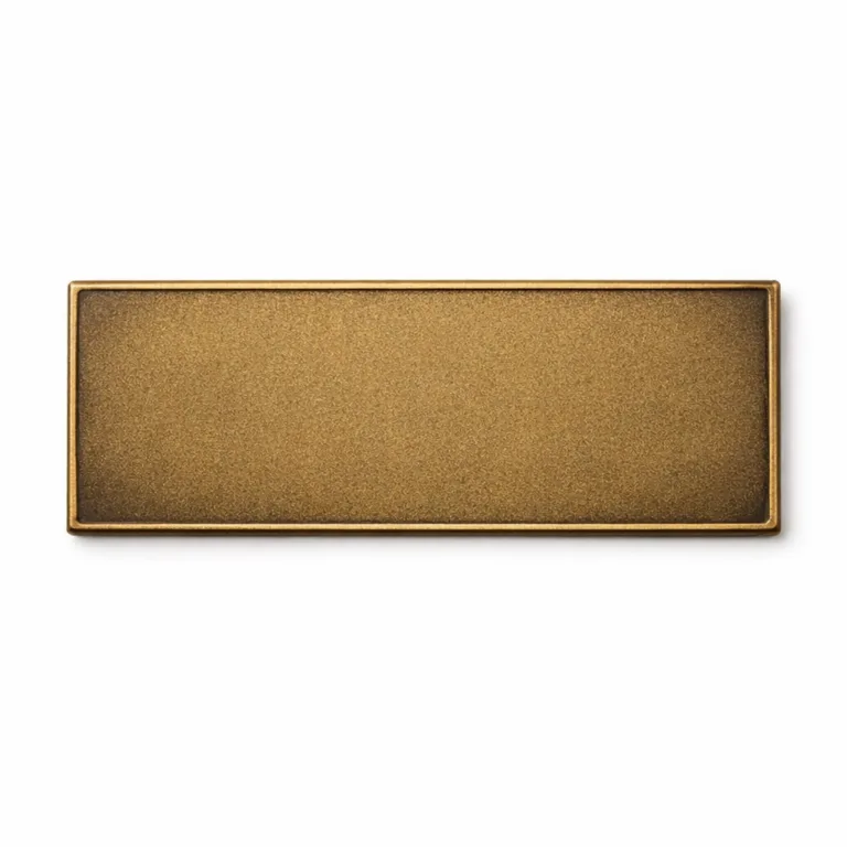 A 2D flat appliance brand nameplate crafted from brass with an antique brass finish and sandblasted matte texture for a vintage look. No mounting holes, ideal for adhesive application. Shot in a commercial studio setting.