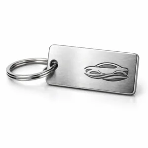 A rectangular car dealer key tag in brushed silver zinc alloy, featuring an engraved emblem and smooth rounded edges, attached to a classic split ring. Ideal for highlighting minimalist quality in an automotive context.
