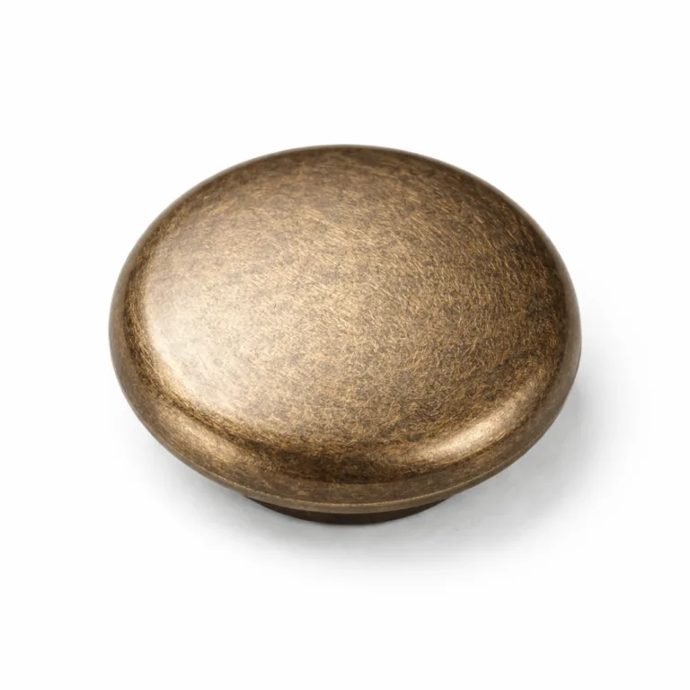 A soft rounded edge snap button cap in electroplated antique brass finish featuring a subtle engraved, slightly textured surface for an elegant, classic look.