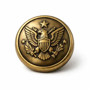 Antique brass colored zinc alloy uniform button with engraved 3D relief logo, designed with a soft rounded edge for classic uniforms.