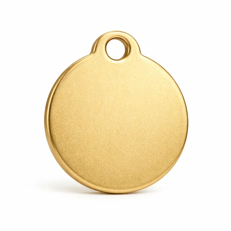A round gold-plated metal tag with a sandblasted matte brass finish, featuring a soft rounded edge for a subtle contemporary look. Designed for durable marking and identification purposes.