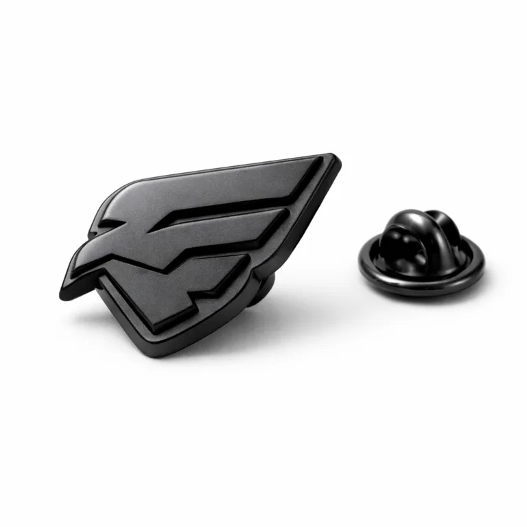 A matte black electroplated badge showcasing a 3D relief emblem and soft rounded edges. The badge is shown from a lapel pin view with a butterfly clutch back attachment. High realism and sharp details make it ideal for e-commerce use.