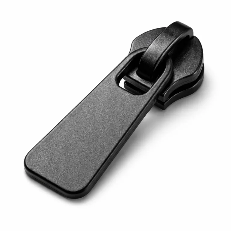 A 2D flat profile zipper puller made from zinc alloy, finished with a sandblasted matte black texture, highlighting a sleek and minimalist look under studio lighting.