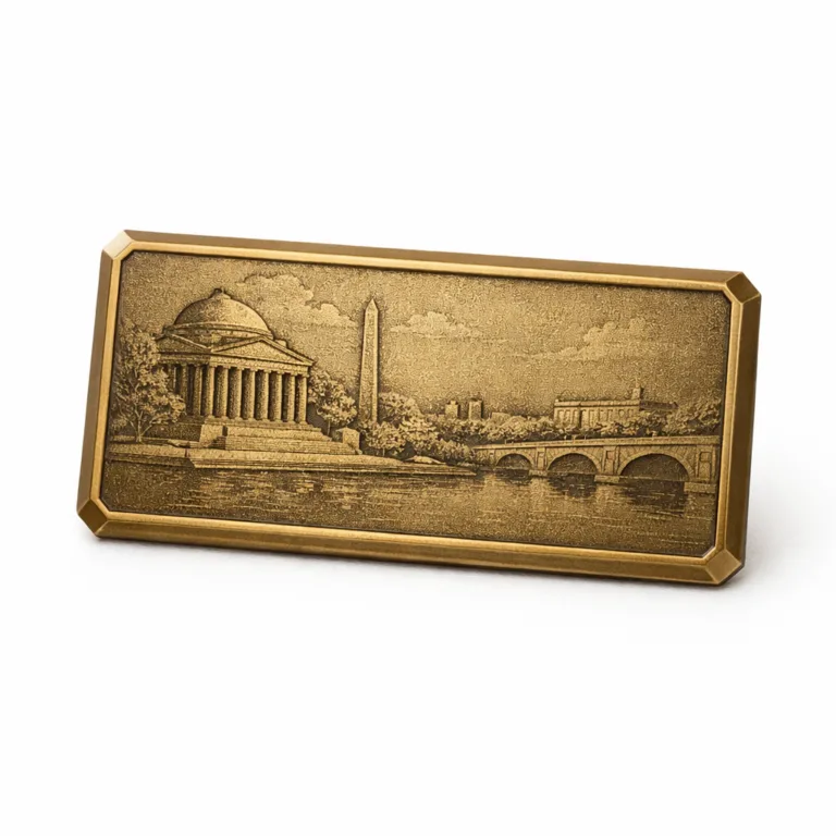 A rectangular metal museum keepsake in antique brass, featuring a flat, etched design with a sandblasted matte texture and beveled edge. The simple 2D engraving provides a classic look without color fill.