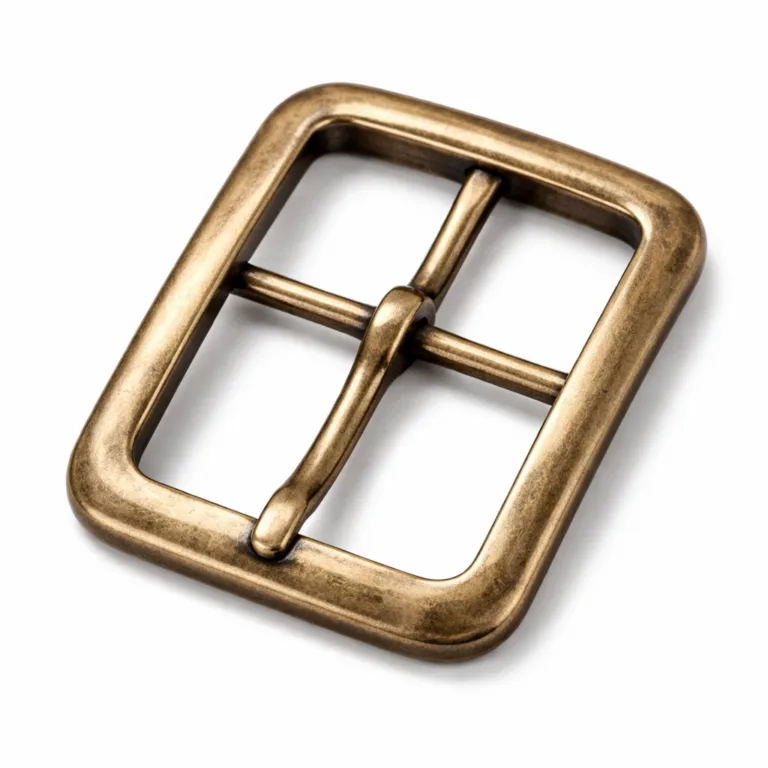 A stamped brass belt buckle frame featuring an antique brass finish and soft rounded edge. The subtle aged surface texture gives it a vintage appearance, with a detailed edge and sturdy prong.