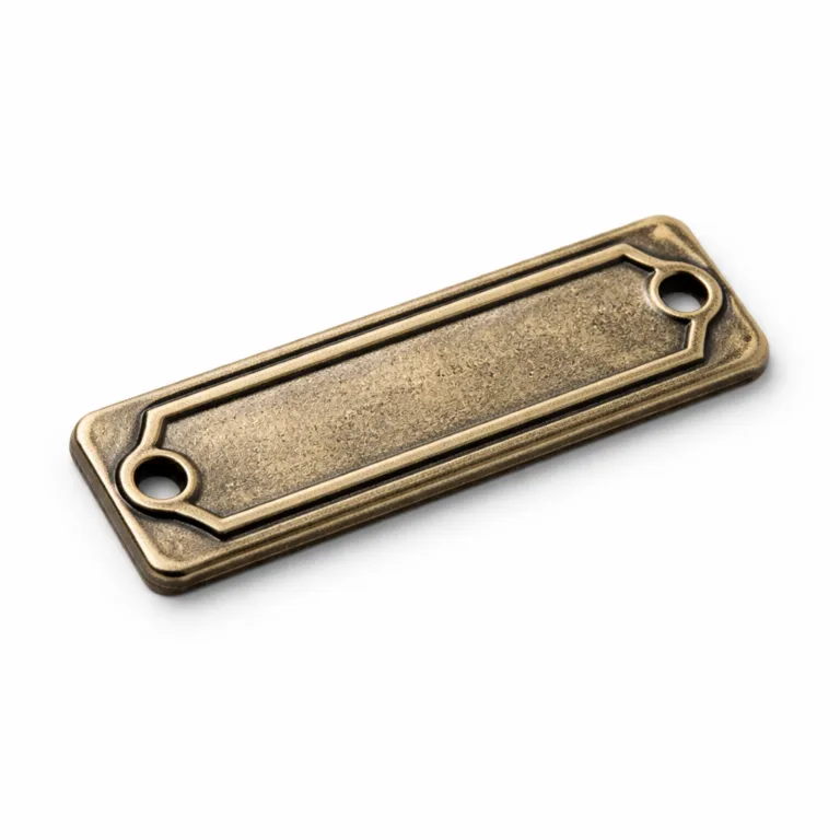 Rectangular antique brass garment tag plate with a lightly textured finish and raised 3D relief outline, offering a vintage appearance and durable details for garment branding.
