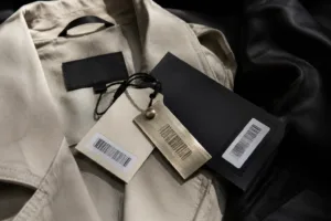 A high-resolution retail environment with premium hang tags and visible barcoded tags on product displays, illustrating both brand and tracking utility.