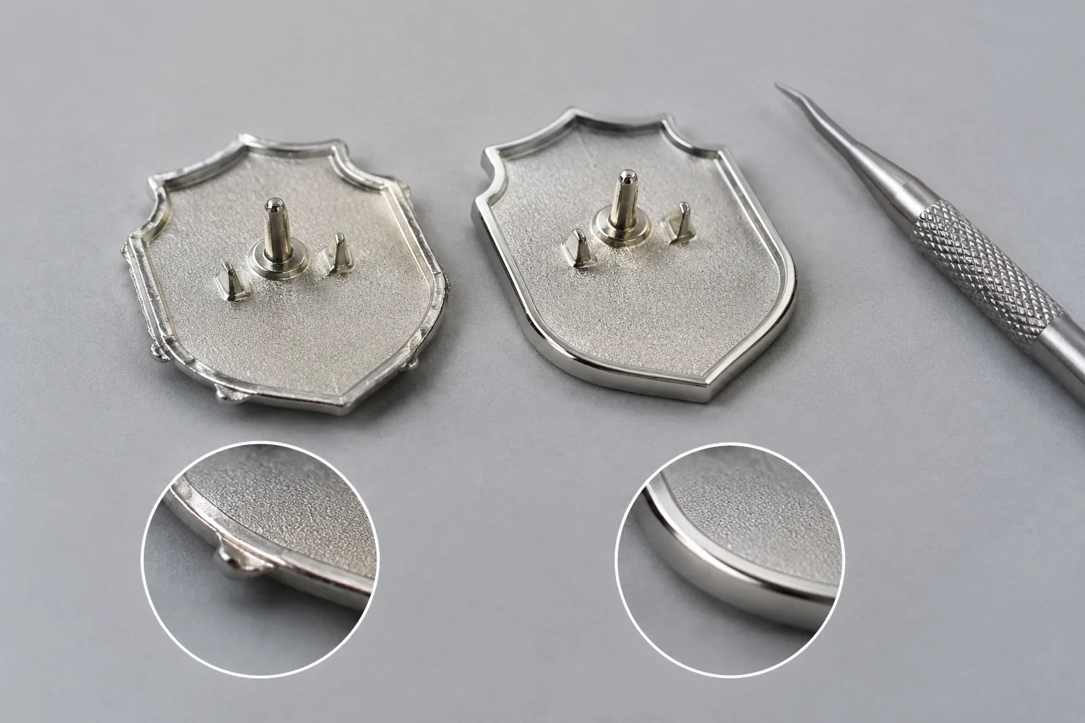 Unbranded zinc-alloy badge components showing an edge burr and a cleaned plated border during inspection