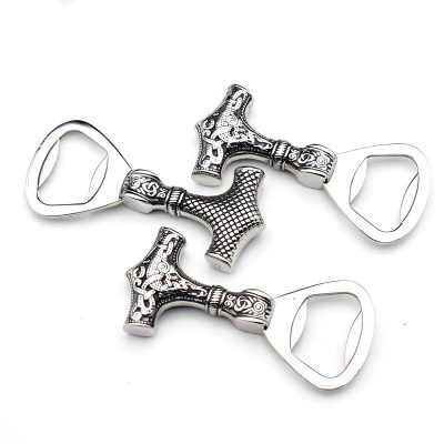 Silver, ornate cross-shaped bottle openers.